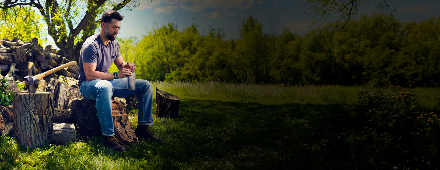 Man having a break with Packed MRE menu after chopping wood