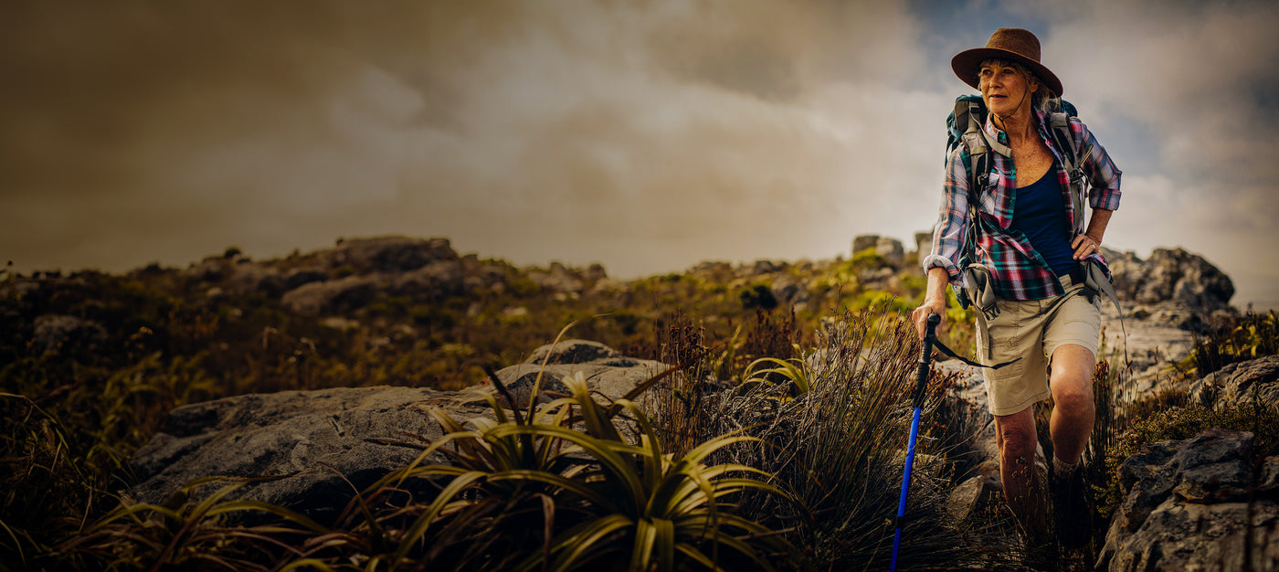 Longevity lifestyle with elderly woman hiking happily