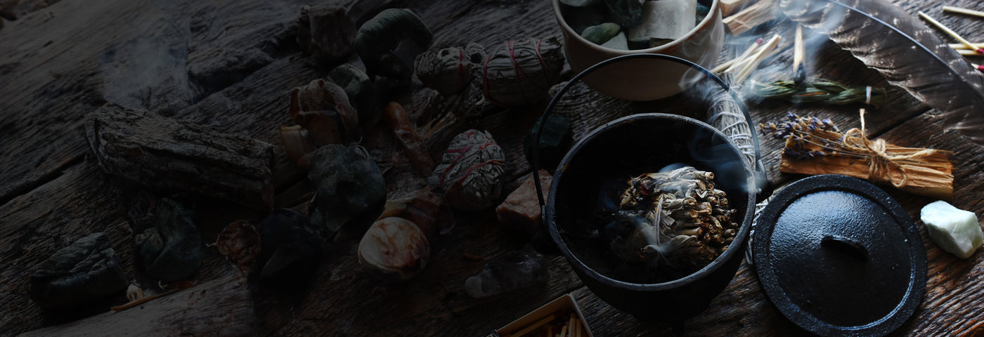 Burning sage bundle with smoke rising in a bowl
